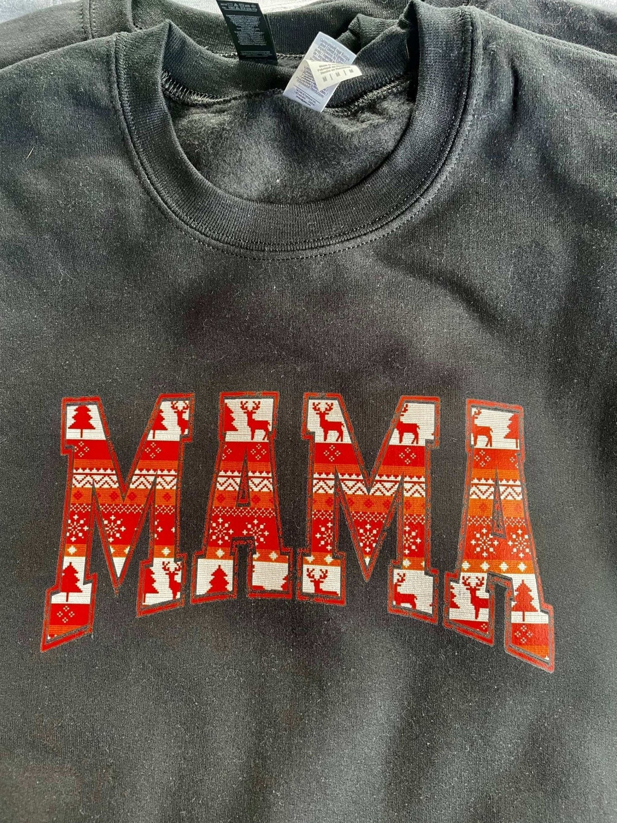 Black crewneck sweatshirt with red and white Native print "MAMA" design, comfortable and stylish cotton crewneck.