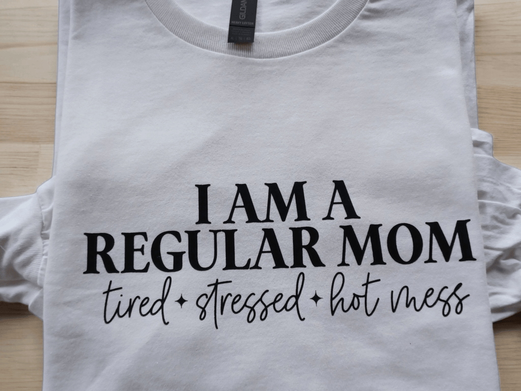 White custom t-shirt with "I AM A REGULAR MOM tired stressed hot mess" text, long sleeve cotton tee for moms