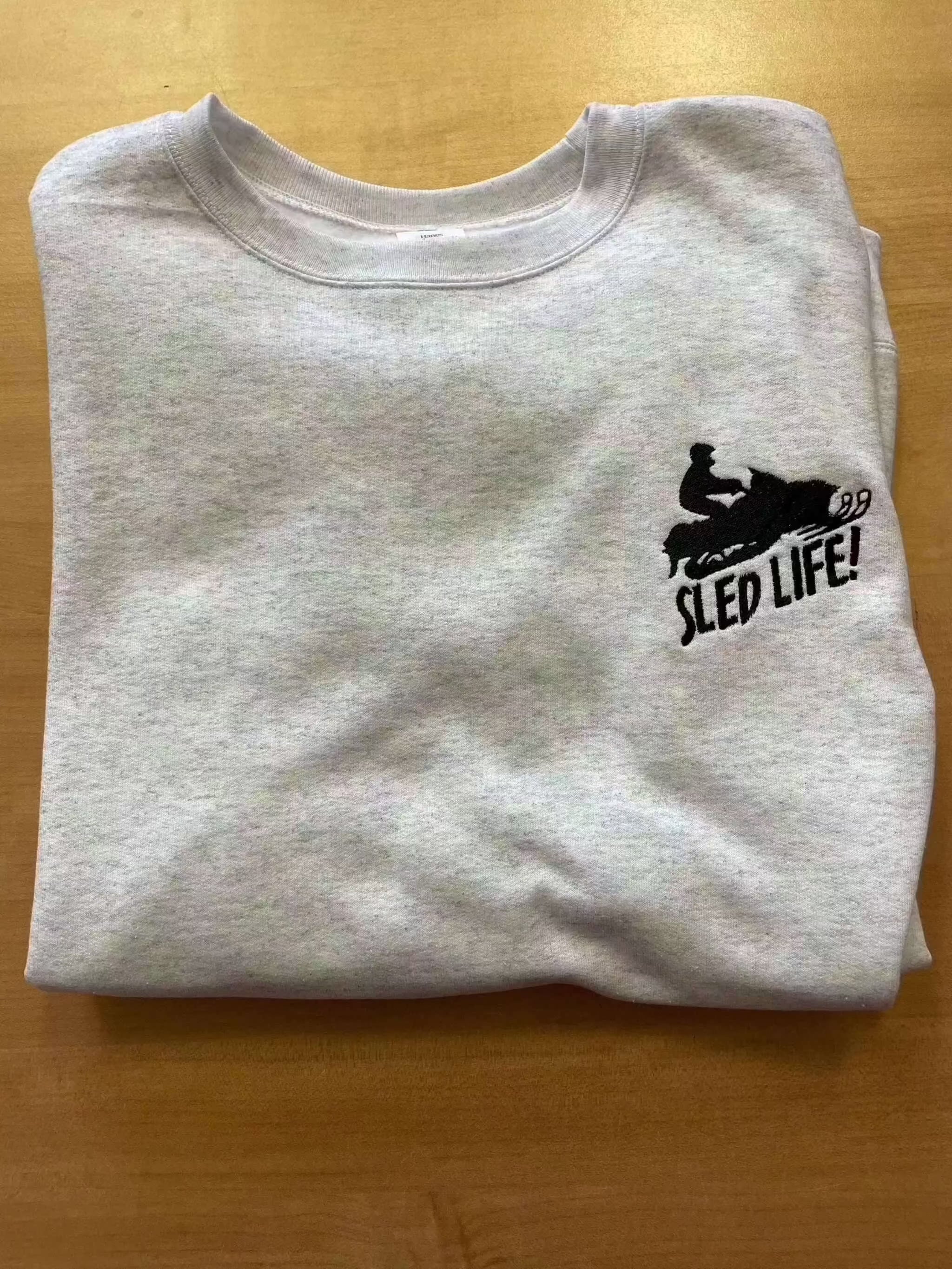 Grey cotton crewneck sweatshirt with embroidered snowmobile sled and "SLED LIFE!" text for snowmobile sled lovers