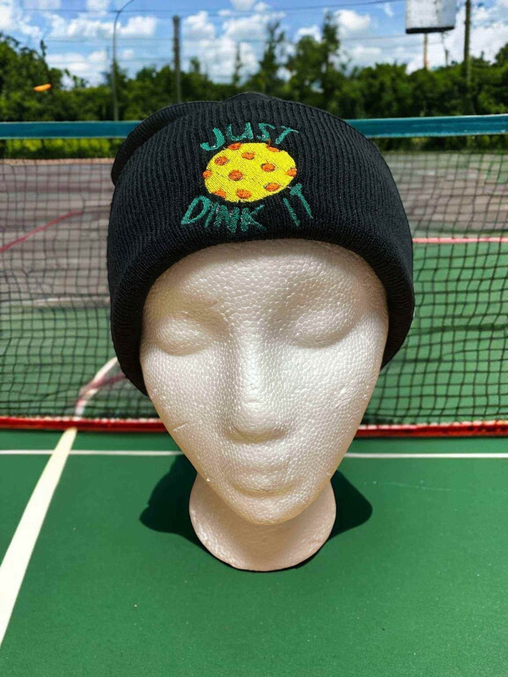 Black beanie with "Just Dink It" embroidered logo featuring a pickleball design, warm and soft knit.