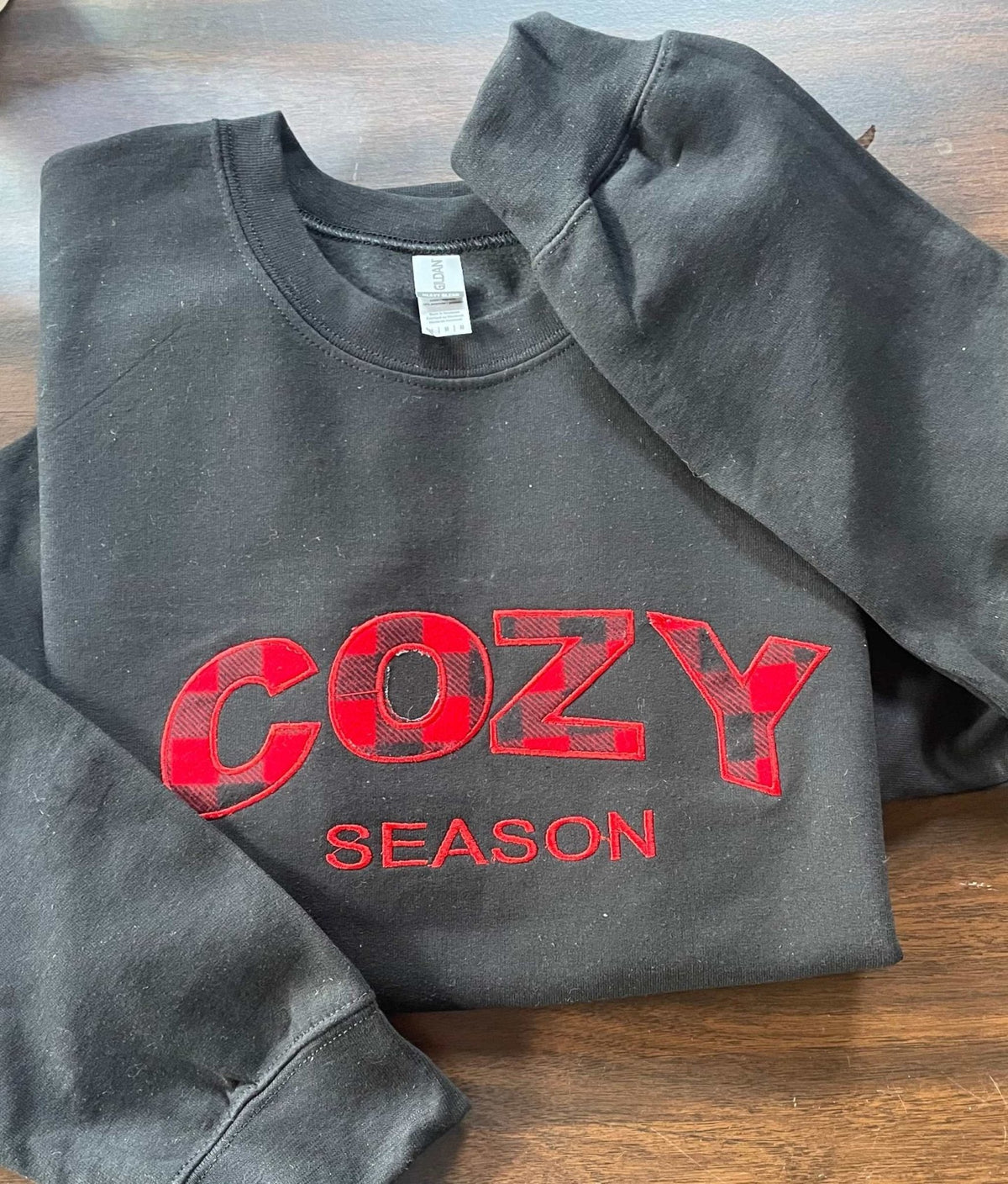 black Cozy Season Crewneck sweatshirt with red buffalo plaid embroidered lettering